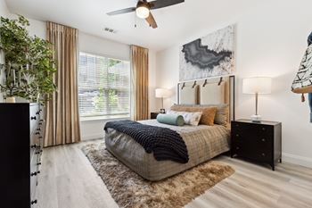 a bedroom with a bed and a ceiling fan
